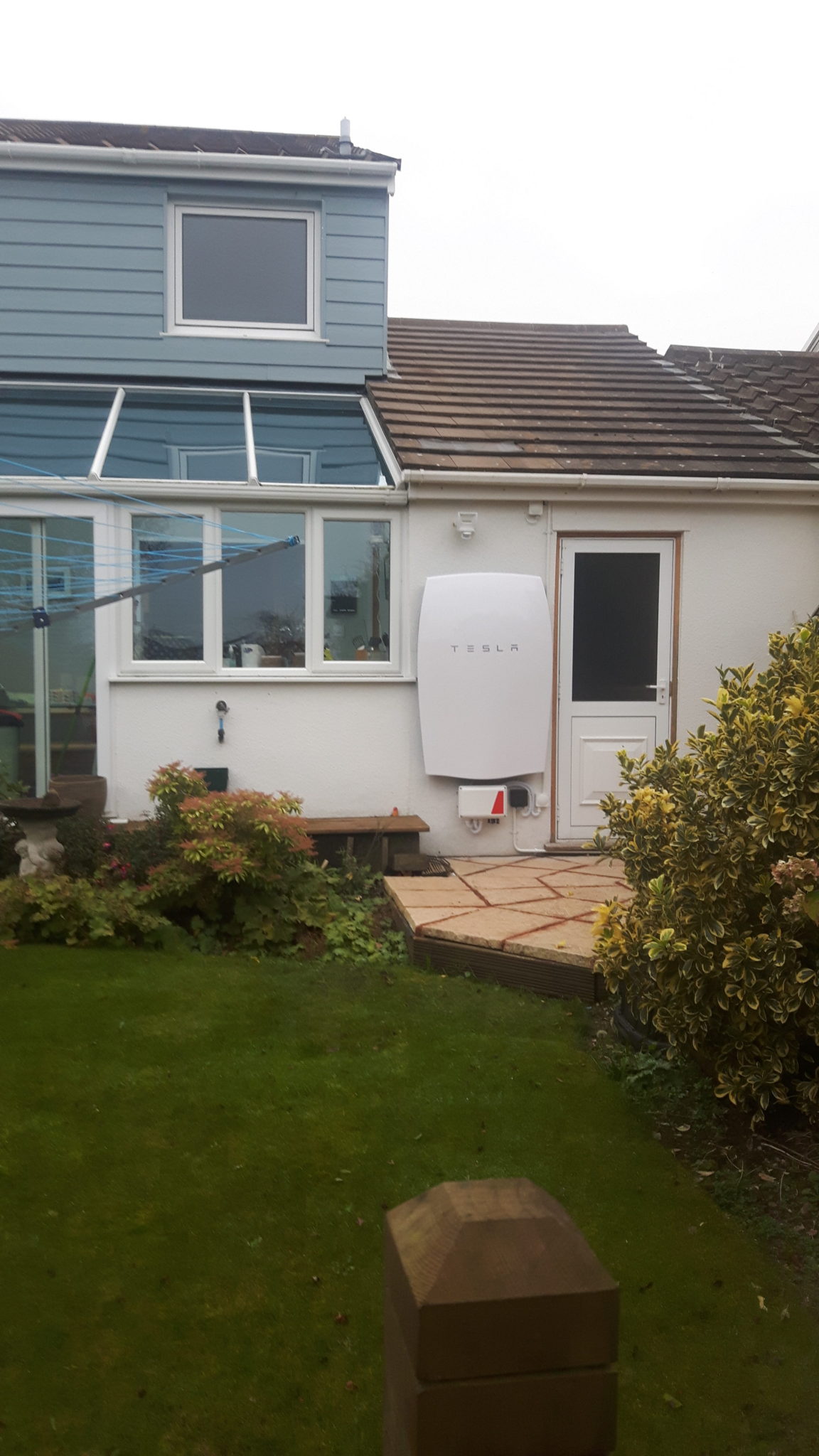 A 6.4kWh Tesla Powerwall battery storage unit installed on the outside of a property near Truro.